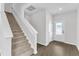 Bright foyer featuring hardwood floors, a carpeted staircase, and white painted trim at 601 Benton Dr, Oxford, NC 27565