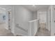Upstairs hallway with carpet, white trim, and doors to rooms at 601 Benton Dr, Oxford, NC 27565