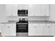 Kitchen showcasing stainless steel oven and microwave with white cabinets and granite countertop at 601 Benton Dr, Oxford, NC 27565