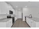 Modern kitchen features white cabinets, stainless steel appliances and granite countertops at 601 Benton Dr, Oxford, NC 27565