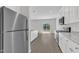 Modern kitchen features stainless steel appliances, granite countertops, and white cabinets with slider to outdoors at 601 Benton Dr, Oxford, NC 27565