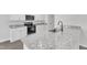 Modern kitchen features granite countertops, stainless steel appliances, and white cabinets at 601 Benton Dr, Oxford, NC 27565