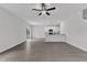 Bright and airy living space showcases hardwood floors, modern lighting, and a partial view of the kitchen at 601 Benton Dr, Oxford, NC 27565