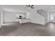 Open-concept living room with vinyl floors, neutral walls, and a modern kitchen with white cabinets at 601 Benton Dr, Oxford, NC 27565
