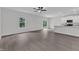 Open-concept living area with hardwood flooring, a ceiling fan, and a seamless transition to the kitchen at 601 Benton Dr, Oxford, NC 27565