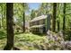 View of home featuring a screened porch and flower garden in backyard at 6105 Splitrock Trl, Apex, NC 27539