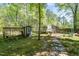 Backyard featuring a chicken coop and a stone pathway through garden at 6105 Splitrock Trl, Apex, NC 27539