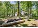Spacious backyard featuring a garden with garden beds and mature trees at 6105 Splitrock Trl, Apex, NC 27539