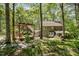 Backyard with a pergola and deck with seating, perfect for outdoor relaxation at 6105 Splitrock Trl, Apex, NC 27539