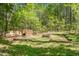 Secluded backyard featuring a cozy fire pit and a wood pile at 6105 Splitrock Trl, Apex, NC 27539
