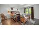 Cozy bedroom featuring a wooden bed frame, hardwood floors, and natural light at 6105 Splitrock Trl, Apex, NC 27539