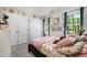Bright bedroom features closet, natural light, floral decor, and plush bedding at 6105 Splitrock Trl, Apex, NC 27539