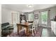 Bright dining room featuring a wooden table and chairs, classic decor, and ample natural light at 6105 Splitrock Trl, Apex, NC 27539