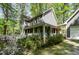 Charming home featuring a welcoming front porch and lush landscaping at 6105 Splitrock Trl, Apex, NC 27539