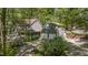 Two-story home featuring a detached two-car garage and a brick patio area, all nestled in a wooded setting at 6105 Splitrock Trl, Apex, NC 27539