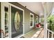 Charming front porch with a comfortable porch swing, decorative door, and ample natural light at 6105 Splitrock Trl, Apex, NC 27539