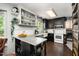 Well-lit kitchen with custom cabinets, open shelving, and stainless steel appliances at 6105 Splitrock Trl, Apex, NC 27539