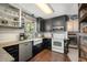 Charming kitchen with an apron-front sink, black cabinetry, and hardwood floors at 6105 Splitrock Trl, Apex, NC 27539