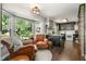Bright kitchen showcasing a bay window, dark cabinets, and hardwood floors at 6105 Splitrock Trl, Apex, NC 27539