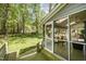 Relaxing screened-in porch with outdoor seating and wooded views at 6105 Splitrock Trl, Apex, NC 27539