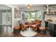 Inviting sitting area featuring leather chairs and a bay window overlooking a lush outdoor space at 6105 Splitrock Trl, Apex, NC 27539