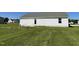 The home's backyard features a grassy lawn, partial fencing, and a small back porch at 70 Pate Landing Dr, Selma, NC 27576