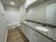 Well-lit bathroom with double vanity sinks, granite countertops and modern fixtures at 70 Pate Landing Dr, Selma, NC 27576