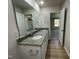 Contemporary bathroom with a double sink vanity, granite countertop, and wood look floors at 70 Pate Landing Dr, Selma, NC 27576