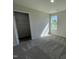 Bright bedroom featuring plush carpeting, natural light, and a closet for storage at 70 Pate Landing Dr, Selma, NC 27576
