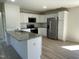 The kitchen offers stainless appliances, granite counters, white cabinets and hardwood floors at 70 Pate Landing Dr, Selma, NC 27576