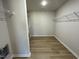 Spacious walk-in closet with wood-look flooring and wire shelving for optimal storage at 70 Pate Landing Dr, Selma, NC 27576