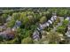 Aerial view of a neighborhood featuring tree-lined streets and well-kept homes with diverse designs at 703 Midsummer Ln, Apex, NC 27502