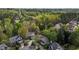Aerial view of a neighborhood with mature trees and well-maintained homes in a suburban setting at 703 Midsummer Ln, Apex, NC 27502