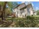 Exterior view of a home with a spacious backyard, wooden deck, and mature shade trees at 703 Midsummer Ln, Apex, NC 27502