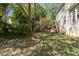 Expansive backyard with lush greenery and a wooden deck, offering plenty of space for outdoor activities at 703 Midsummer Ln, Apex, NC 27502