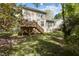 Well-maintained backyard featuring a wooden deck, lawn, and mature trees offering great outdoor living at 703 Midsummer Ln, Apex, NC 27502