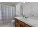 Well-lit bathroom featuring a decorative shower curtain and vanity with storage at 703 Midsummer Ln, Apex, NC 27502