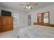 Spacious bedroom with a ceiling fan and access to the ensuite bathroom at 703 Midsummer Ln, Apex, NC 27502