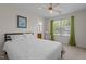 Comfortable bedroom with a ceiling fan, bright window with curtains, and access to the bathroom at 703 Midsummer Ln, Apex, NC 27502