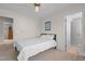 Cozy bedroom with neutral carpet, ceiling fan, and a view into the bathroom at 703 Midsummer Ln, Apex, NC 27502