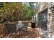 Outdoor deck with a table, chairs, grill, and sliding door leading to the home's interior at 703 Midsummer Ln, Apex, NC 27502