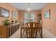 Traditional dining room with wooden table set, decorative chandelier, and ample natural light at 703 Midsummer Ln, Apex, NC 27502