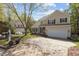 A well-kept house with a spacious driveway, lawn, and charming curb appeal at 703 Midsummer Ln, Apex, NC 27502