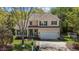 Charming two-story home with a well-manicured lawn, garage, and front porch, exudes curb appeal at 703 Midsummer Ln, Apex, NC 27502
