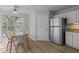 Bright breakfast nook with stainless steel refrigerator and backyard views at 703 Midsummer Ln, Apex, NC 27502