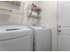 Laundry room with washer, dryer, and storage shelves at 703 Midsummer Ln, Apex, NC 27502