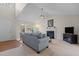 Bright living room with a vaulted ceiling, neutral decor, and cozy fireplace at 703 Midsummer Ln, Apex, NC 27502