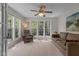 Sunlit living room with neutral colors and large windows overlooking trees at 703 Midsummer Ln, Apex, NC 27502