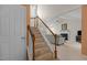 Carpeted staircase with white railings leading to a living room with fireplace at 703 Midsummer Ln, Apex, NC 27502