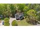 An aerial view showcases this traditional two-story home's setting, lush landscaping, and long driveway at 720 Raymond Dr, Clayton, NC 27527